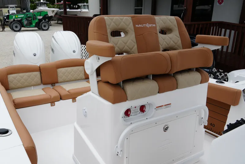 Slide: The Image of 2025 NauticStar 252 Legacy boat interior with tan and beige seating. - 20