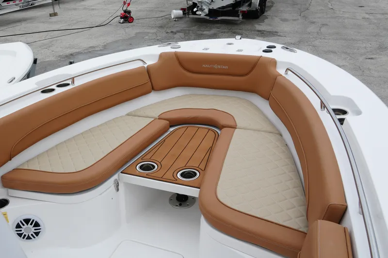 Slide: The Image of 2025 NauticStar 252 Legacy boat with tan seating and cup holders. - 22