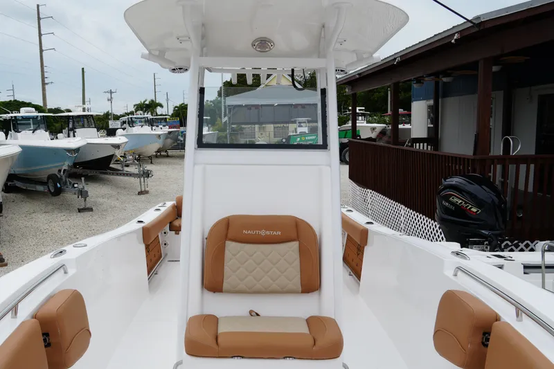 Slide: The Image of 2025 NauticStar 252 Legacy boat interior with tan seating and modern design. - 24