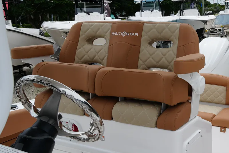 Slide: The Image of 2025 NauticStar 252 Legacy boat seats with luxurious tan and beige upholstery. - 25