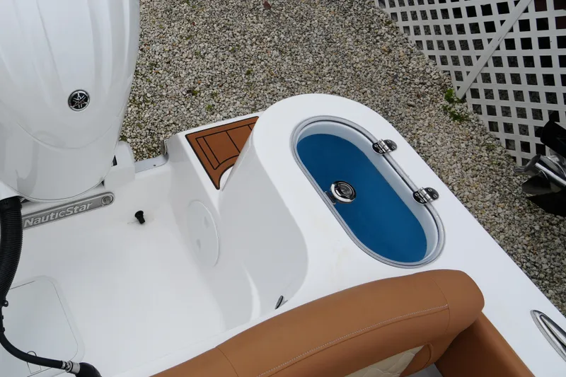 Slide: The Image of 2025 NauticStar 252 Legacy boat interior with livewell and seating detail. - 27