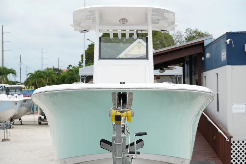 Slide: The Image of 2025 NauticStar 252 Legacy boat front view at a marina. - 4