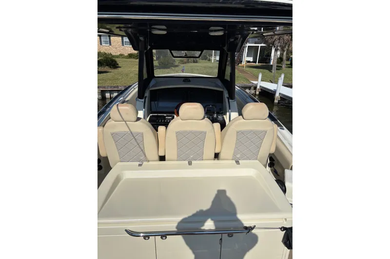 Slide: The Image of 2018 Chris-Craft 350 Catalina boat interior with beige seats and control panel. - 10