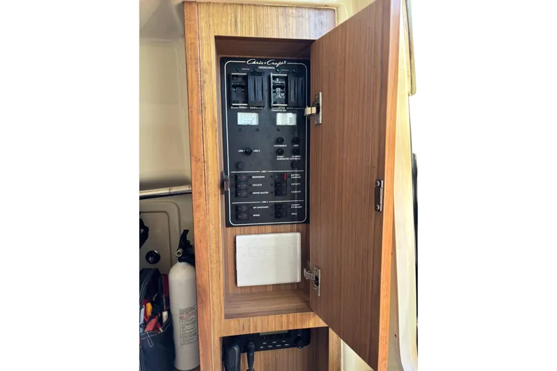Slide: The Image of Electrical panel inside 2018 Chris-Craft 350 Catalina boat, featuring switches and controls. - 14
