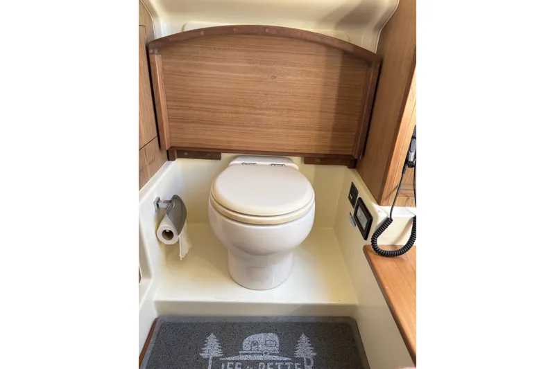 Slide: The Image of 2018 Chris-Craft 350 Catalina bathroom with wooden accents and modern fixtures. - 15