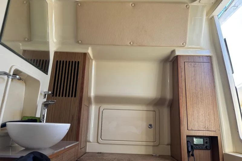 Slide: The Image of 2018 Chris-Craft 350 Catalina interior with sink, wooden cabinets, and modern design. - 16