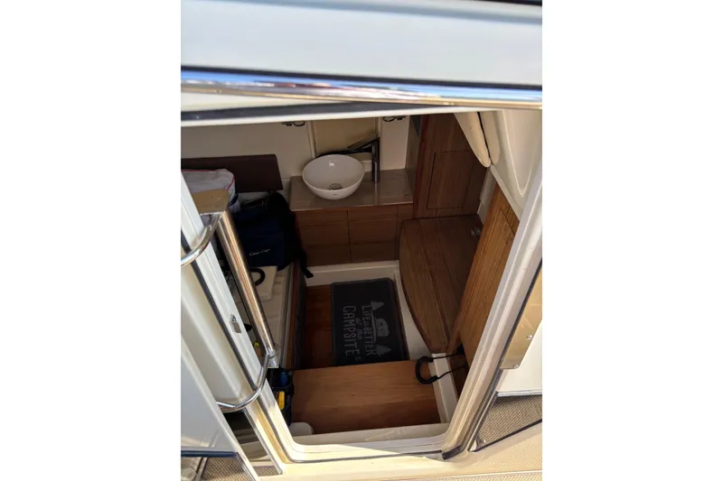 Slide: The Image of 2018 Chris-Craft 350 Catalina cabin interior with wooden flooring and compact sink. - 17