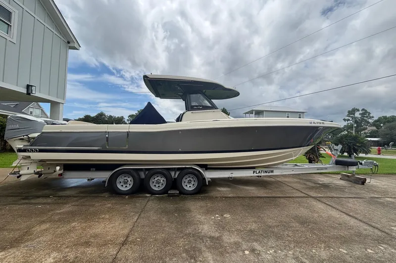 The Image of 2018 Chris-Craft 350 Catalina boat on trailer, parked outdoors under cloudy sky. - 1