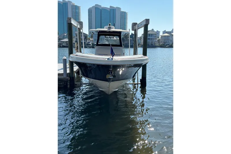 Slide: The Image of 2018 Chris-Craft 350 Catalina docked in a marina with cityscape background. - 22