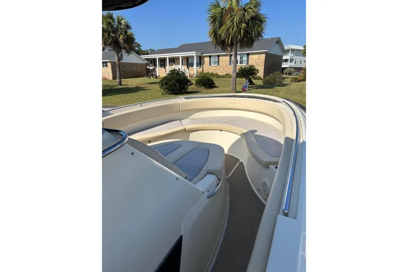 Slide: The Image of 2018 Chris-Craft 350 Catalina boat with spacious seating, docked near a house and palm trees. - 25