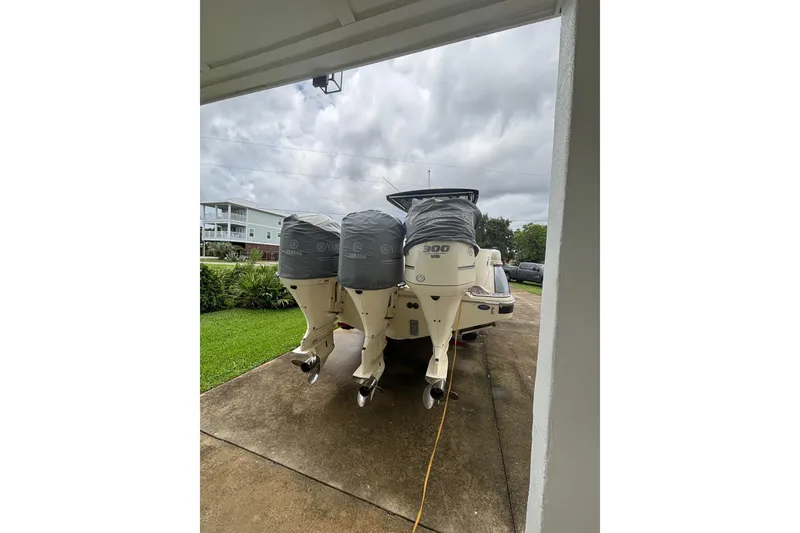 Slide: The Image of 2018 Chris-Craft 350 Catalina with triple Yamaha outboard engines on a driveway. - 3