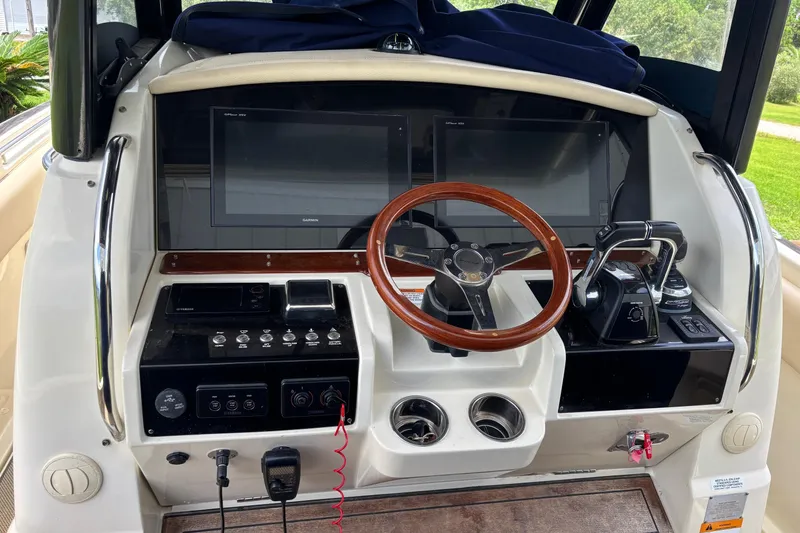 Slide: The Image of 2018 Chris-Craft 350 Catalina helm with wooden steering wheel and modern controls. - 4