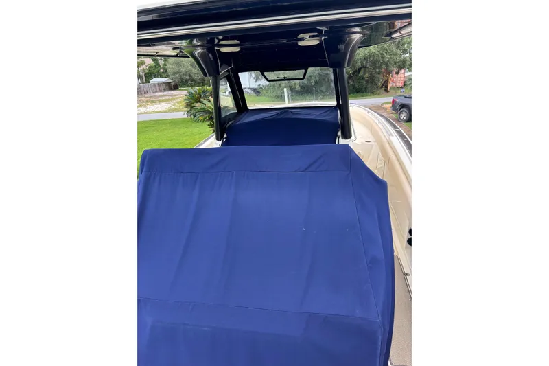 Slide: The Image of 2018 Chris-Craft 350 Catalina boat with blue covers, docked outdoors. - 6