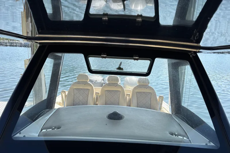 Slide: The Image of 2018 Chris-Craft 350 Catalina boat interior with luxurious seating and water view. - 8