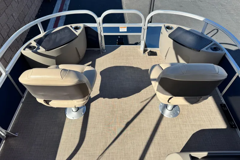 Slide: The Image of 2023 Sun Tracker Bass Buggy 18 DLX interior with two beige seats and storage compartments. - 10