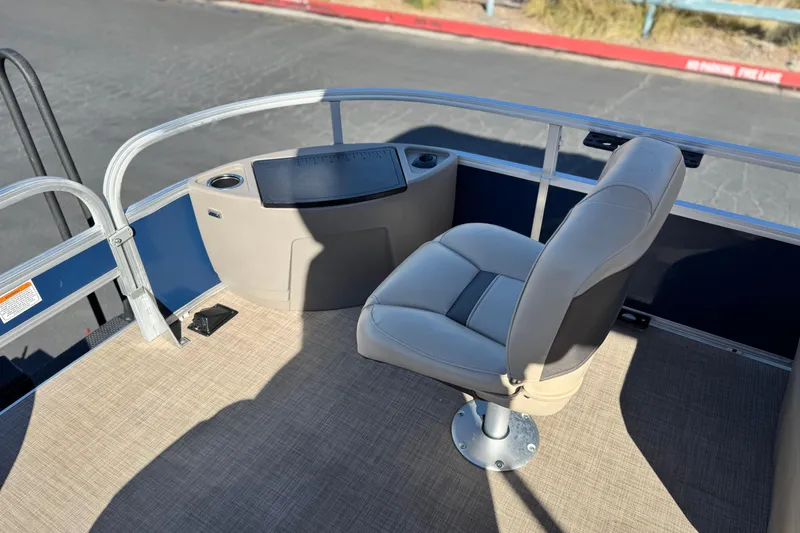 Slide: The Image of 2023 Sun Tracker Bass Buggy 18 DLX boat interior with captain's chair and control panel. - 13