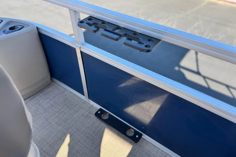 Slide: The Image of 2023 Sun Tracker Bass Buggy 18 DLX interior detail with blue panel and cup holders. - 14