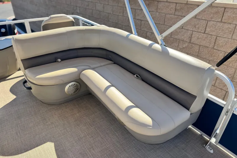Slide: The Image of 2023 Sun Tracker Bass Buggy 18 DLX pontoon boat with beige seating and speaker. - 17