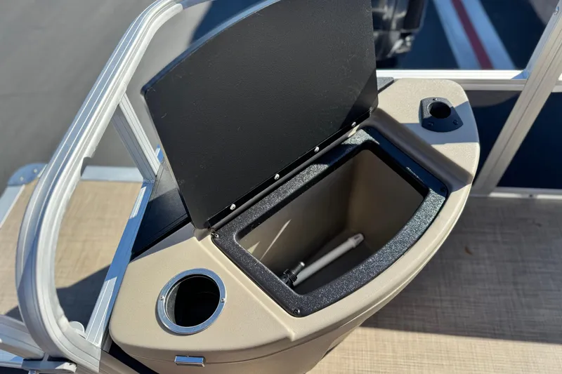 Slide: The Image of 2023 Sun Tracker Bass Buggy 18 DLX boat storage compartment with cup holder. - 20