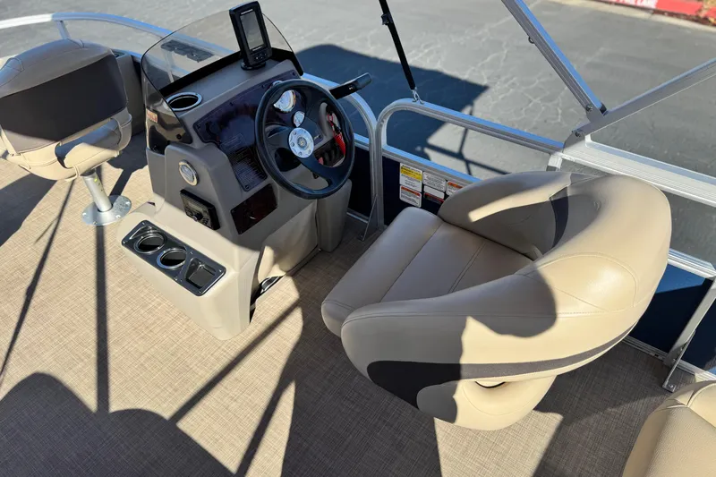 Slide: The Image of 2023 Sun Tracker Bass Buggy 18 DLX boat interior with steering console and seating. - 23