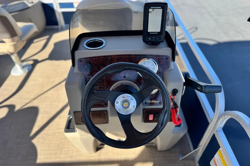 Slide: The Image of 2023 Sun Tracker Bass Buggy 18 DLX steering console with GPS and controls. - 24