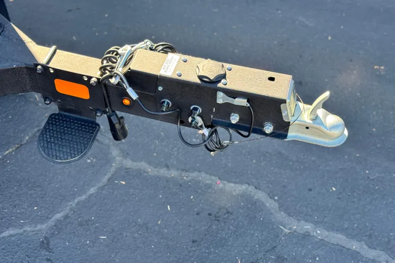 Slide: The Image of Trailer hitch of 2023 Sun Tracker Bass Buggy 18 DLX on asphalt surface. - 28