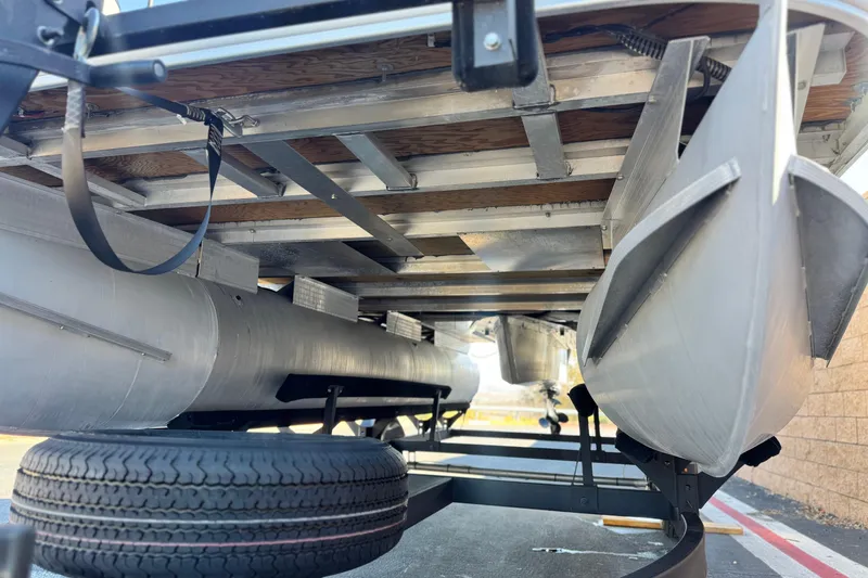Slide: The Image of Underneath view of 2023 Sun Tracker Bass Buggy 18 DLX pontoon boat on trailer. - 4