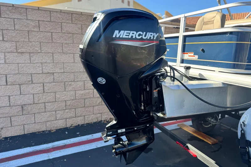 Slide: The Image of 2023 Sun Tracker Bass Buggy 18 DLX with Mercury outboard motor, parked outdoors. - 7