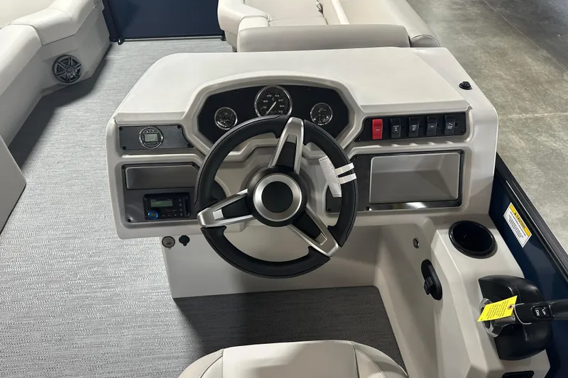 Slide: The Image of 2026 Godfrey Xperience 2286 SBX boat dashboard with steering wheel and control panel. - 6