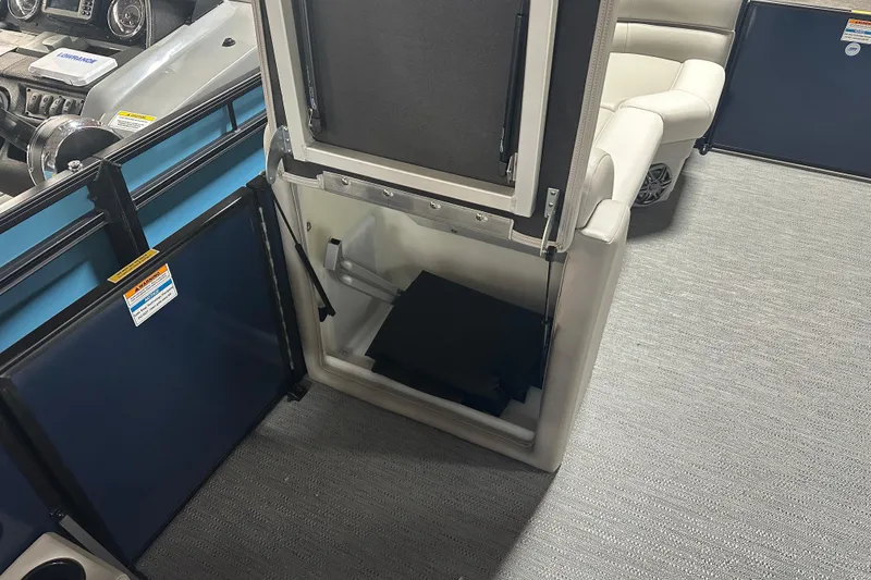 Slide: The Image of 2026 Godfrey Xperience 2286 SBX boat interior with open storage compartment and seating. - 9