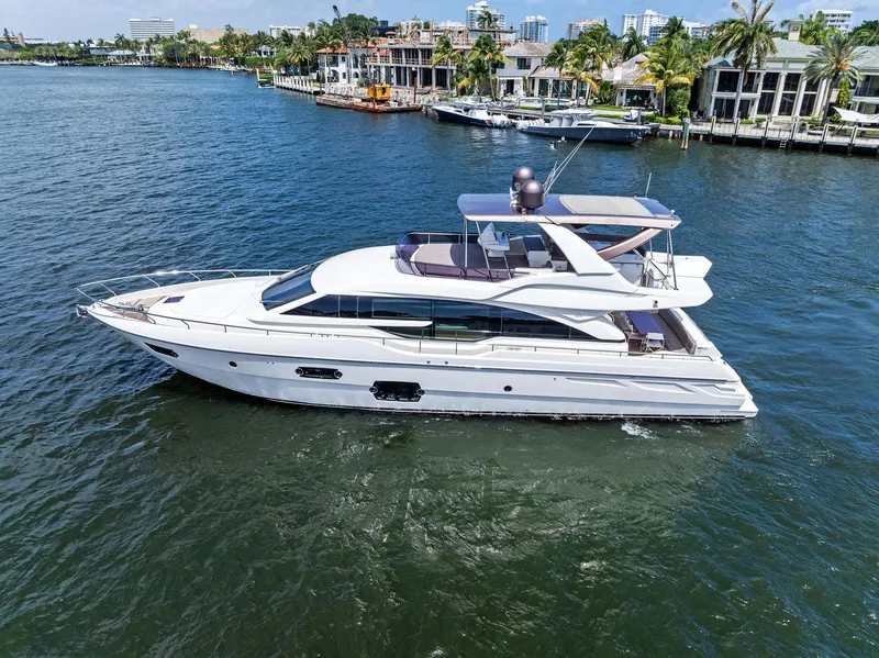 Slide: The Image of Luxurious 2015 Ferretti Yachts 690 cruising on serene waters near waterfront homes. - 12