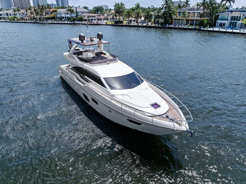 Slide: The Image of 2015 Ferretti Yachts 690 cruising on a sunny day, surrounded by waterfront homes. - 15