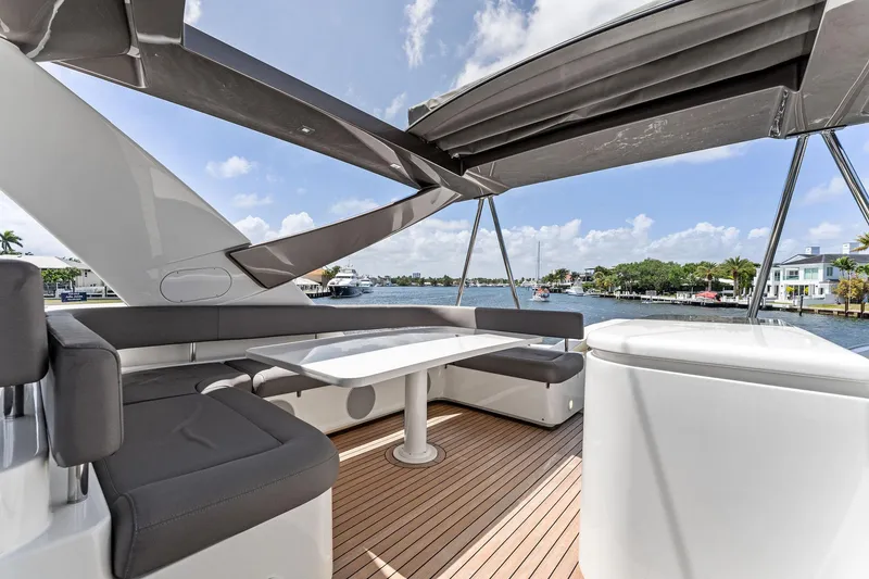 Slide: The Image of Luxurious 2015 Ferretti Yachts 690 with spacious deck seating and scenic waterfront view. - 28