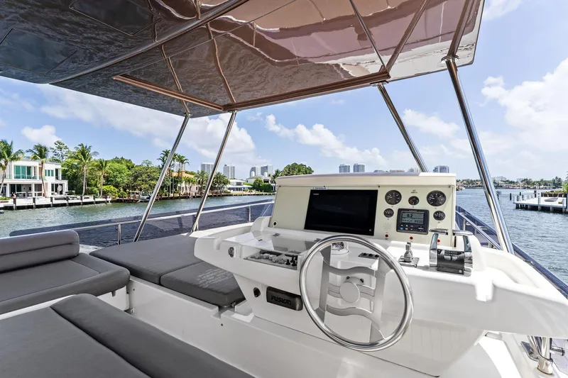 Slide: The Image of Luxurious 2015 Ferretti Yachts 690 helm with waterfront view and modern controls. - 31
