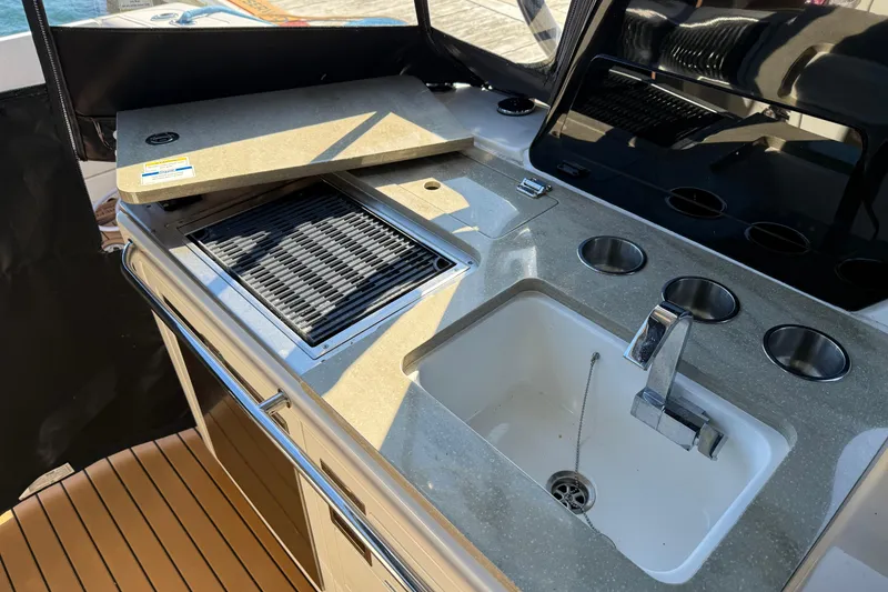 Slide: The Image of Outdoor kitchen on 2024 Boston Whaler 380 Realm with sink and grill. - 10