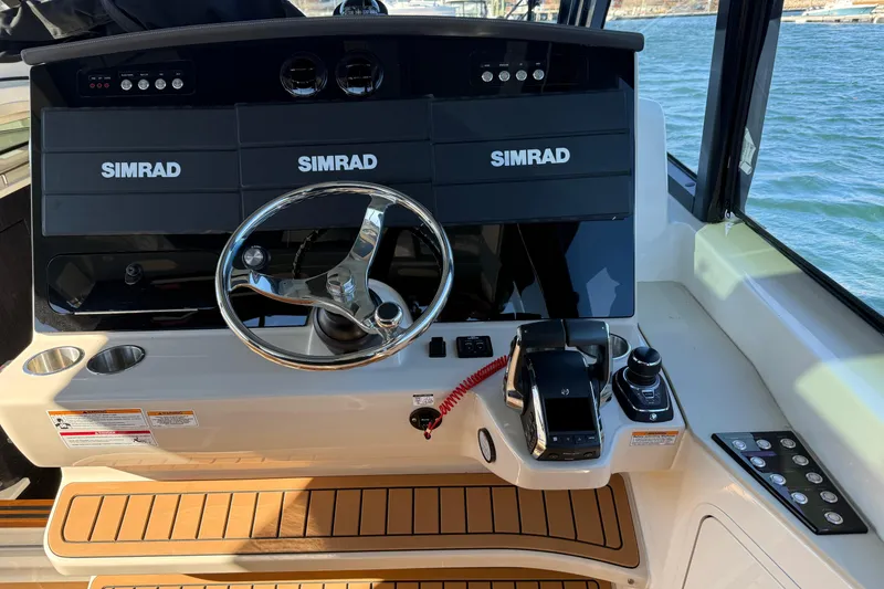 Slide: The Image of 2024 Boston Whaler 380 Realm helm with Simrad electronics and modern controls. - 6