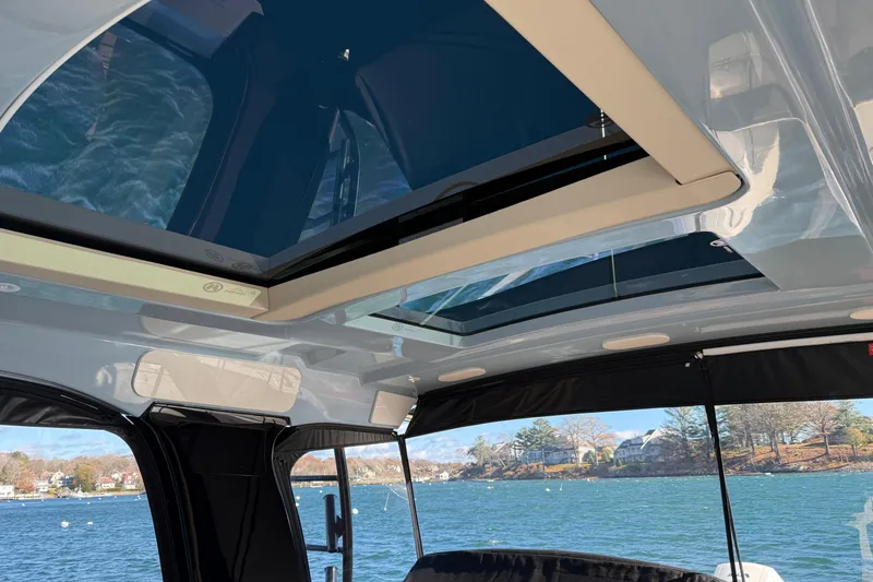 Slide: The Image of 2024 Boston Whaler 380 Realm boat interior with panoramic sunroof view. - 8
