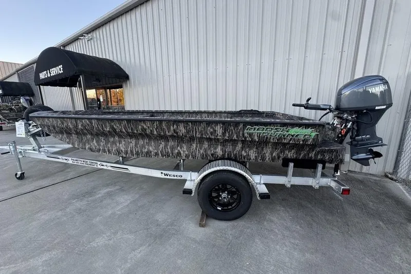 The Image of 2025 Havoc 1756 MRST boat on trailer with Yamaha motor, parked outside service center. - 1