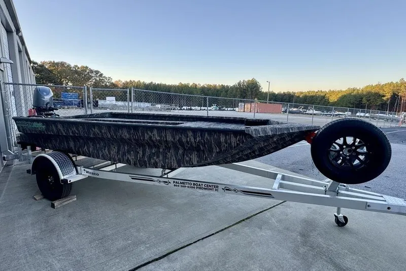 Slide: The Image of 2025 Havoc 1756 MRST boat on trailer, parked outdoors near a fence. - 10