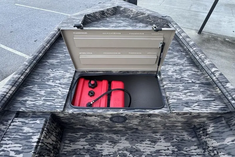 Slide: The Image of 2025 Havoc 1756 MRST boat with open storage compartment and red fuel tank. - 13