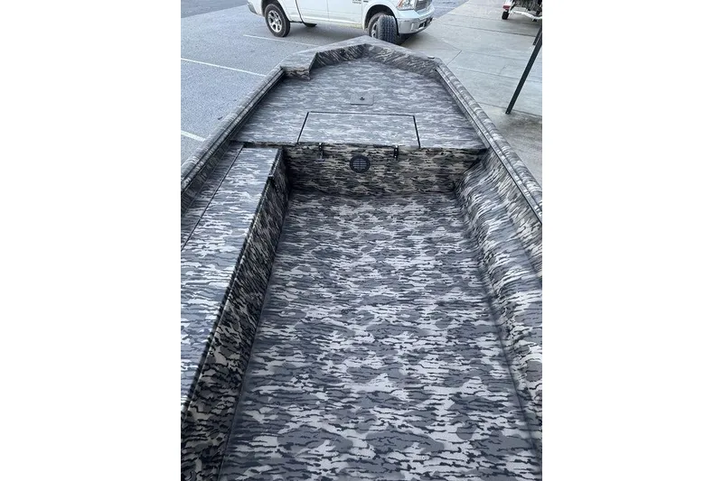 Slide: The Image of 2025 Havoc 1756 MRST boat with camouflage interior, parked in a lot. - 14