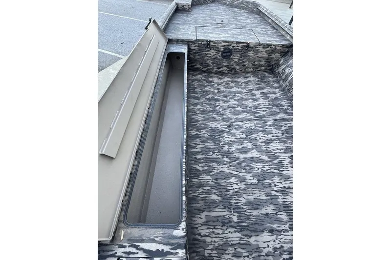 Slide: The Image of 2025 Havoc 1756 MRST boat interior with camo pattern and open storage compartment. - 16