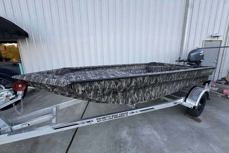Slide: The Image of 2025 Havoc 1756 MRST boat on trailer, camo design, parked outside. - 3
