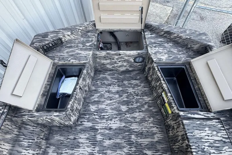 Slide: The Image of 2025 Havoc 1756 MRST boat interior with open storage compartments and camouflage design. - 7