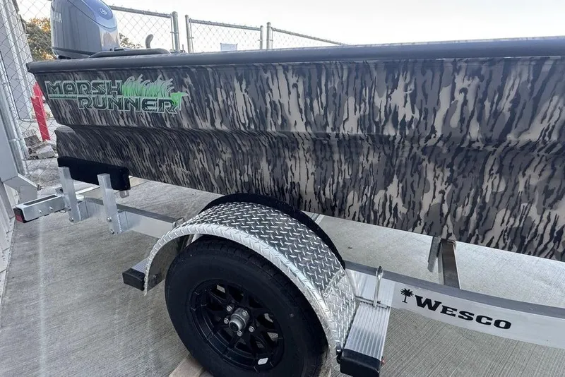 Slide: The Image of 2025 Havoc 1756 MRST boat with camo design on a Wesco trailer. - 8