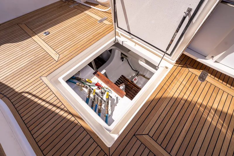 Slide: The Image of Open hatch on 2008 Grand Banks 47 Eastbay FB, revealing storage and equipment. - 16