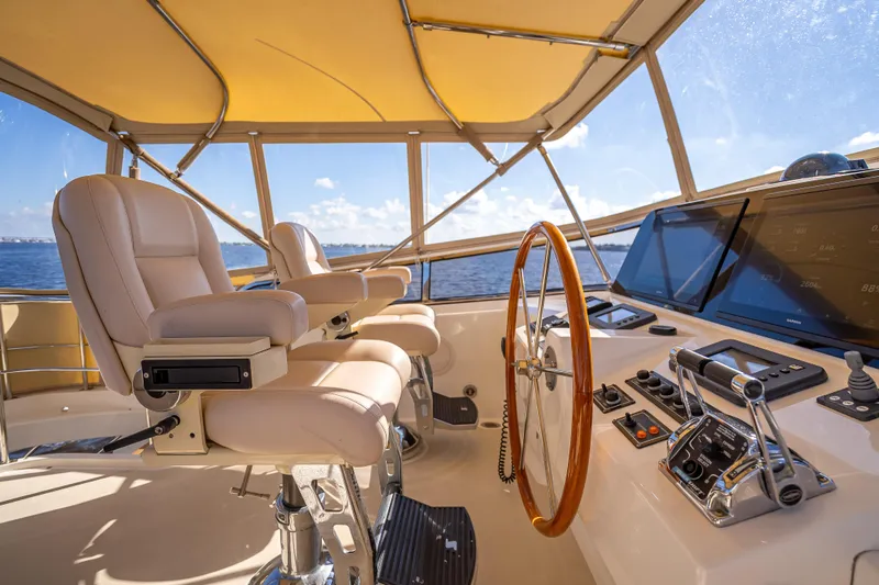 Slide: The Image of Luxurious helm of 2008 Grand Banks 47 Eastbay FB yacht with leather seats and navigation controls. - 24