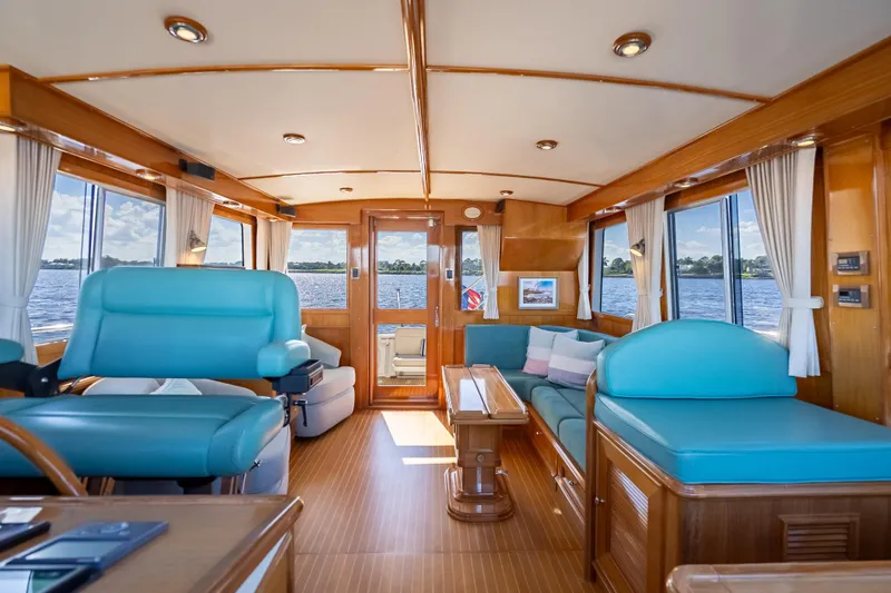 Slide: The Image of Luxurious interior of 2008 Grand Banks 47 Eastbay FB yacht with blue seating and wood finish. - 35