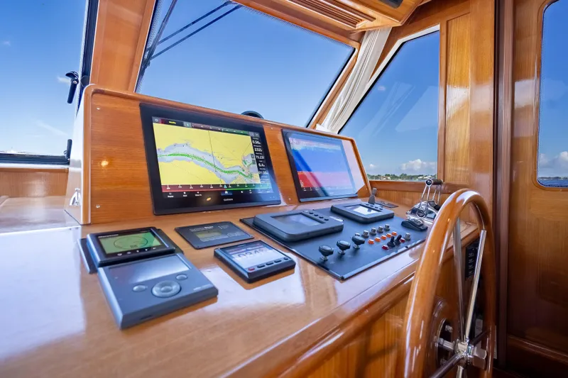 Slide: The Image of Helm of 2008 Grand Banks 47 Eastbay FB with navigation screens and controls. - 38