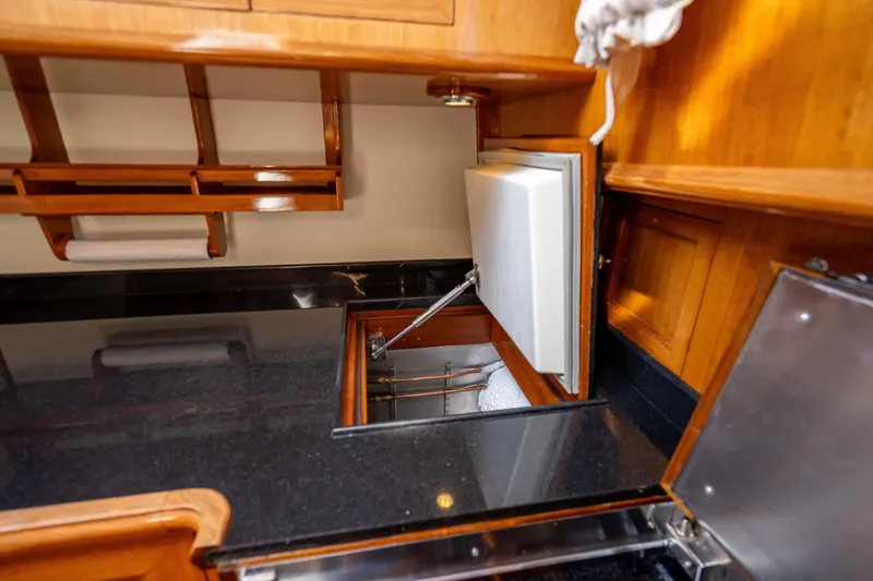 Slide: The Image of 2008 Grand Banks 47 Eastbay FB yacht interior with wooden cabinetry and built-in storage. - 45